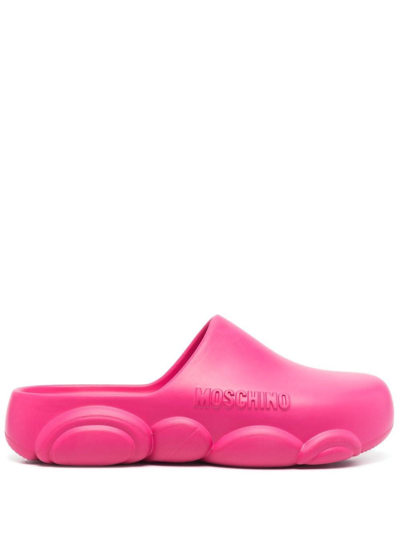 Shop Moschino Mules With Embossed Logo In Pink & Purple