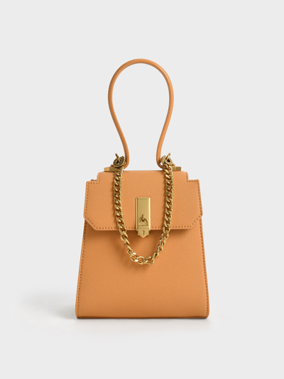 Shop Charles & Keith Geometric Top Handle Chain-link Bag In Pumpkin