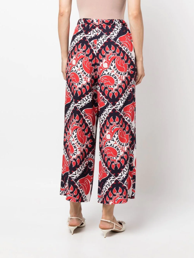 Shop Valentino Archive Manifesto-print Trousers In Rot