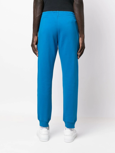 Shop Moschino Logo-print Track Pants In Blau