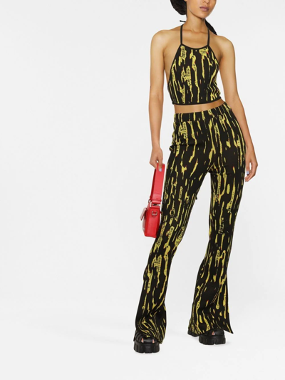 Ambush Graphic Printed Slit Flared Pants In Schwarz
