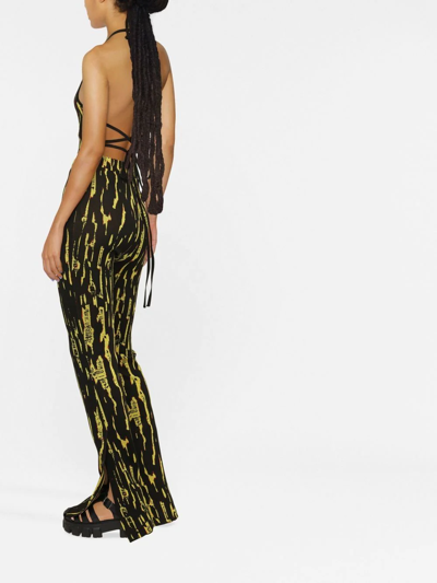 Ambush Graphic Printed Slit Flared Pants In Schwarz