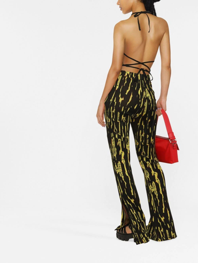 Ambush Graphic Printed Slit Flared Pants In Schwarz