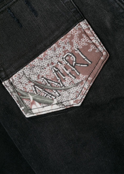 Shop Amiri Aged Black Hibiscus Artpatch Jeans