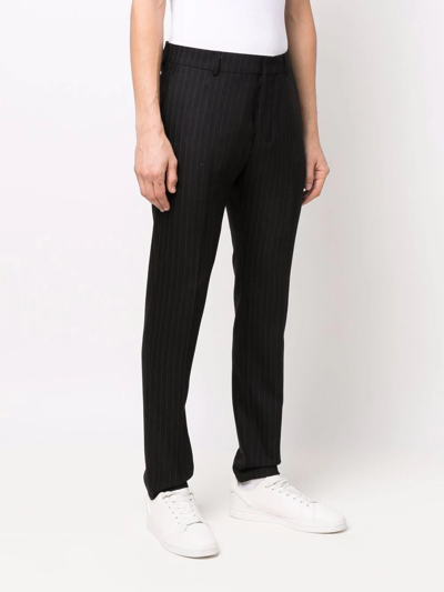 Shop Ami Alexandre Mattiussi Pinstriped Tapered Trousers In Black
