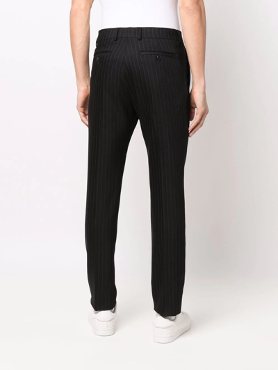 Shop Ami Alexandre Mattiussi Pinstriped Tapered Trousers In Black