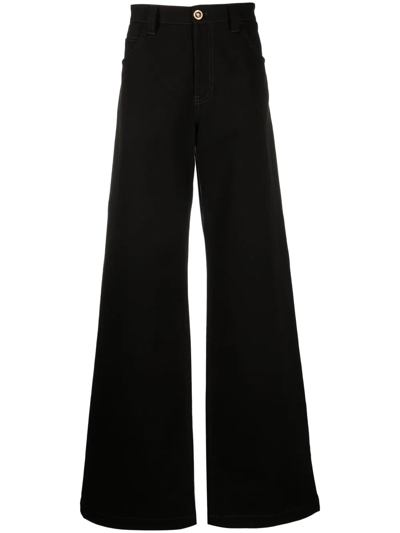 Shop Versace Wide-leg Cotton Trousers In Schwarz