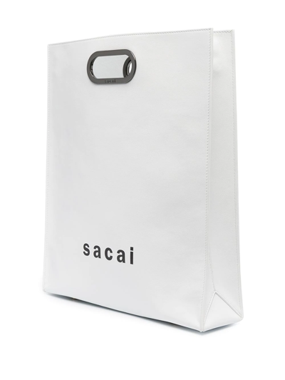 Shop Sacai Logo Print Two-way Bag In White