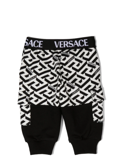 Shop Versace Logo-print Trousers In 黑色
