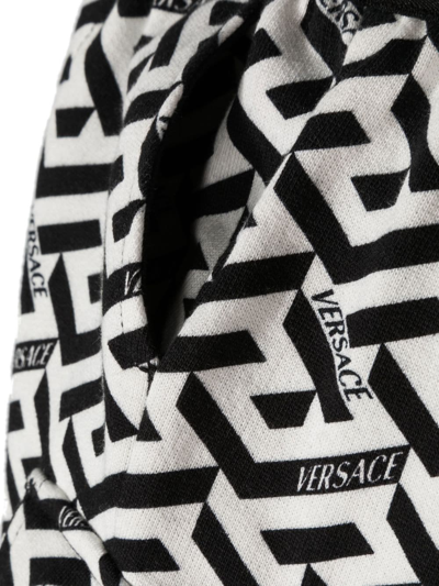 Shop Versace Logo-print Trousers In 黑色