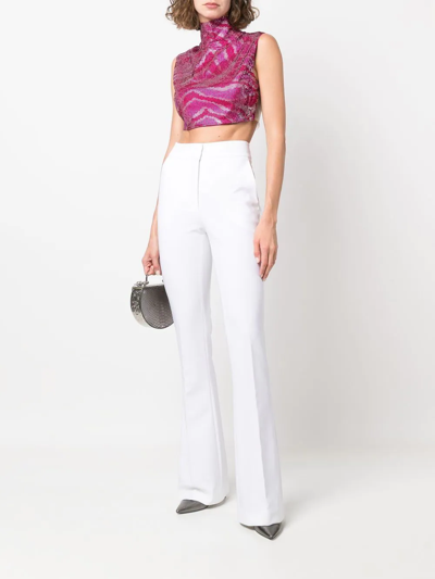 Shop Genny High-waisted Flared Trousers In White