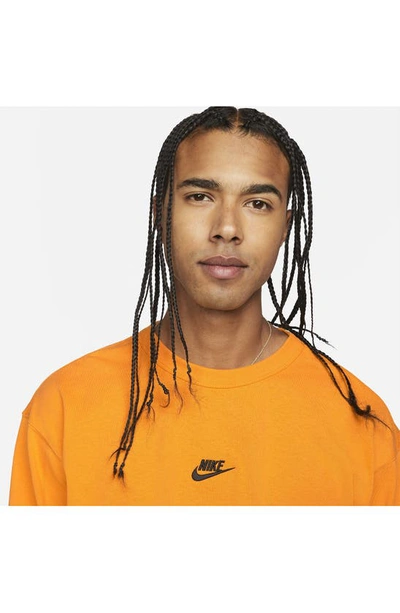 Shop Nike Sportswear Premium Essentials Long Sleeve T-shirt In Kumquat/ Black