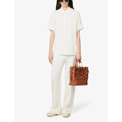 Shop Victoria Beckham Pleated Darted-back Straight-leg Mid-rise Woven Trousers In Off White