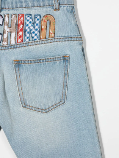 Shop Moschino Logo-patch Slim-cut Jeans In Blue