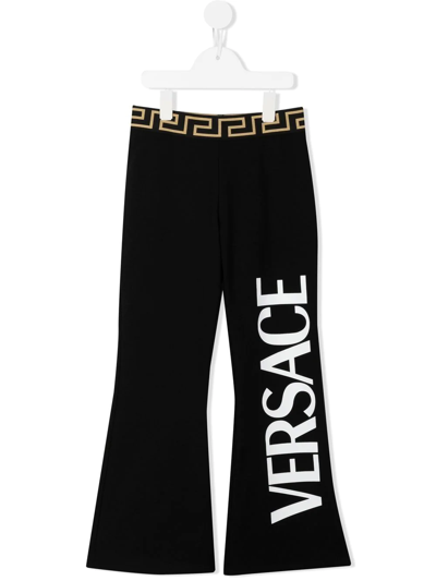 Shop Versace Logo-print Cotton Flared Trousers In Black