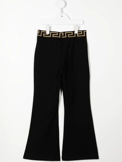 Shop Versace Logo-print Cotton Flared Trousers In Black