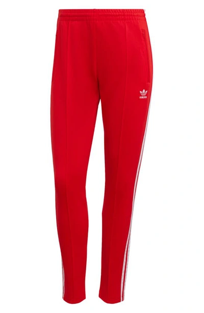 Shop Adidas Originals Primeblue Superstar Track Pants In Vivid Red