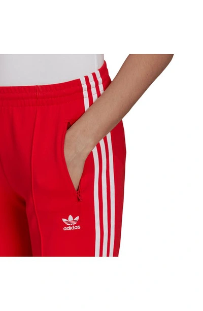 Shop Adidas Originals Primeblue Superstar Track Pants In Vivid Red