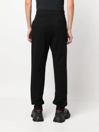 Shop Versace Logo-print Track Pants In Schwarz
