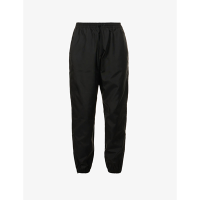 Shop Wardrobe.nyc Relaxed-fit Tapered-leg Mid-rise Shell Trousers In Black