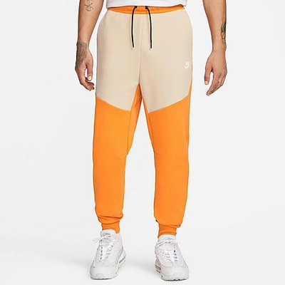 Shop Nike Tech Fleece Taped Jogger Pants In Orange/tan