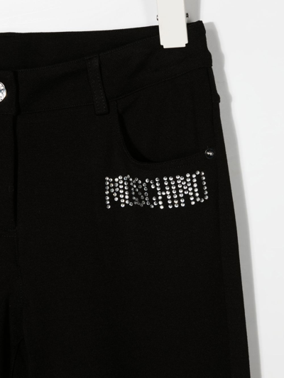 Shop Moschino Embellished-logo Detail Trousers In Black