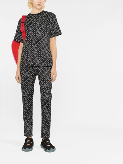 Shop Moncler Logo-print Jersey Trousers In Schwarz