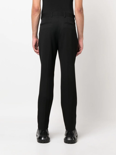 Shop Moschino Mid-rise Slim-cut Trousers In Black