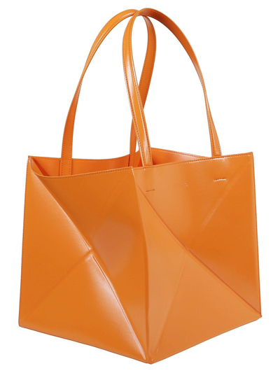 Shop Nanushka Logo Embossed Folded Tote Bag In Orange