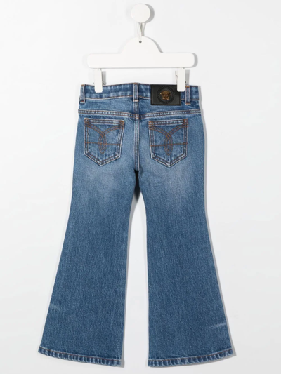 Shop Versace Flared Leg Jeans In Blue