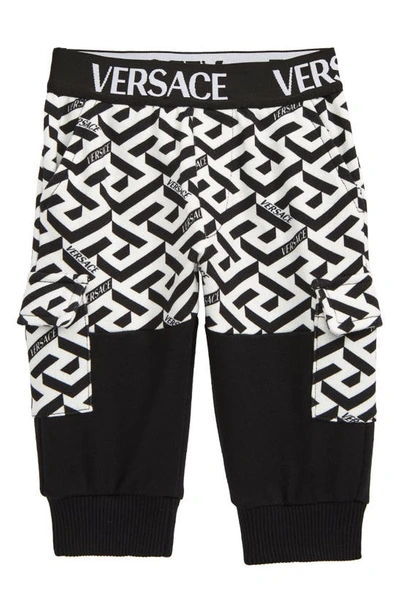 Shop Versace La Greca Cotton Knit Cargo Joggers In White Black