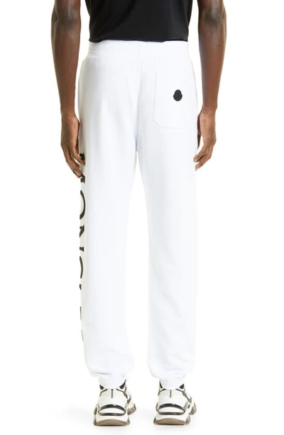 Shop Moncler Embroidered Strike Out Cotton Sweatpants In White