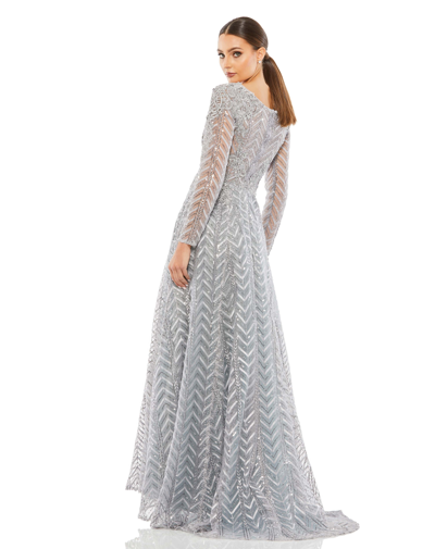 Shop Mac Duggal Embellished Illusion Long Sleeve Wrap Over A Line Gown In Platinum