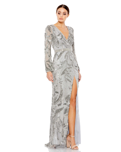 Shop Mac Duggal Sequined Faux Wrap Split Long Sleeve Gown In Platinum