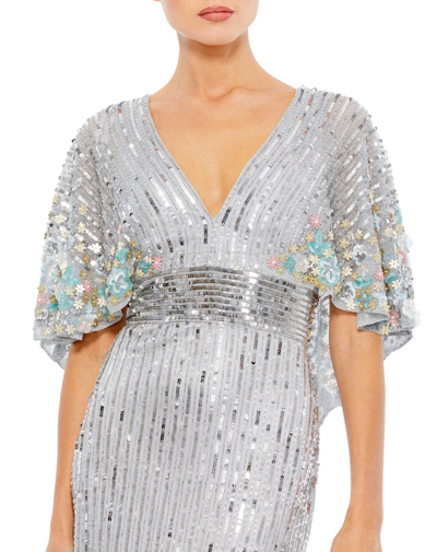 Shop Mac Duggal Sequined V Neck Floral Embellished Cape Sleeve Gown In Platinum