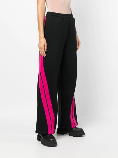 Shop Msgm Flared Stripe-print Track Pants In Black