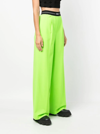 Shop Msgm Logo-waist Wide-leg Trousers In Green