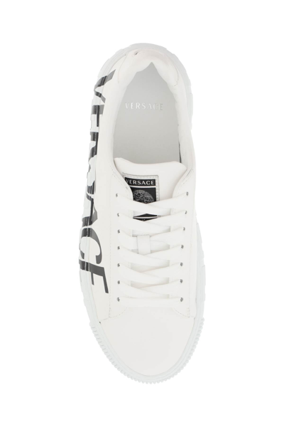 Shop Versace Logoed Greca Sneakers In White