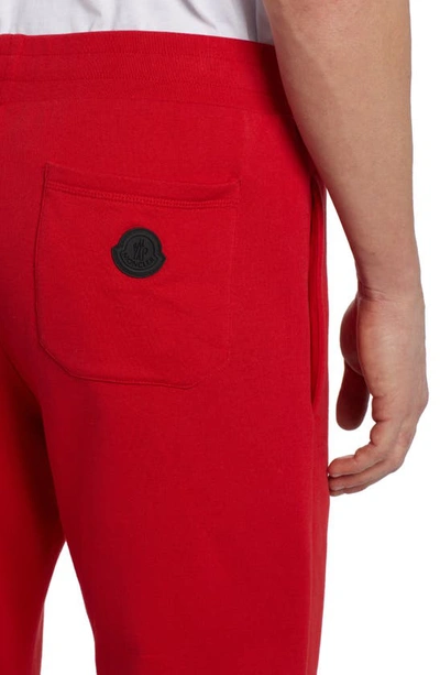Shop Moncler Embroidered Strike Out Cotton Sweatpants In Red
