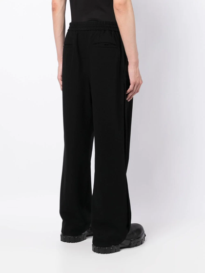 Shop Juunj Wide-leg Elasticated-waist Trousers In Black