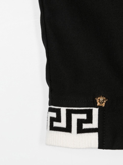 Shop Versace Medusa-motif Greca-trim Trousers In Black
