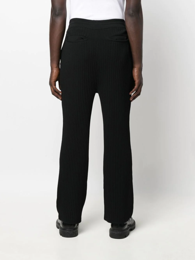 Shop Nanushka Ribbed-knit Straight-leg Trousers In Black