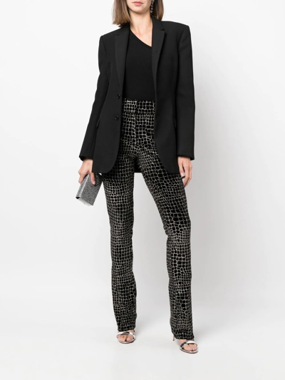 Shop Genny Crocodile-effect Velvet Flared Trousers In Schwarz