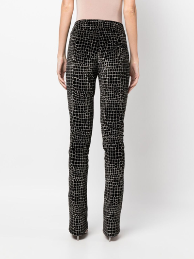 Shop Genny Crocodile-effect Velvet Flared Trousers In Schwarz