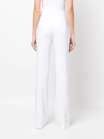 Shop Genny High-waisted Flared Trousers In Weiss