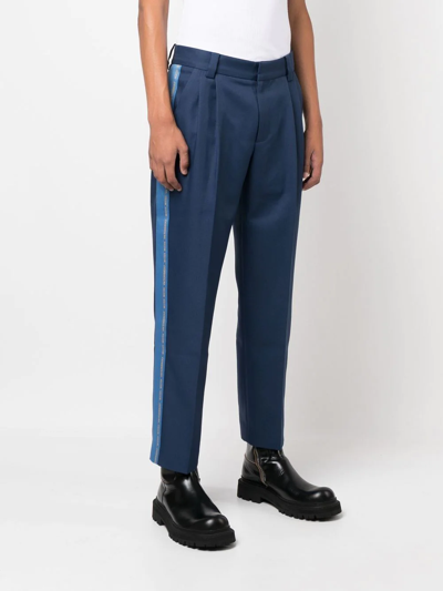 Shop Viktor & Rolf Embroidered-logo Cropped Trousers In Blue