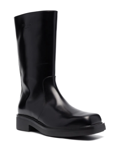 Shop Prada Debossed-logo Leather Boots In Black