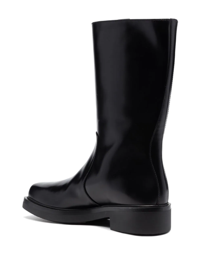 Shop Prada Debossed-logo Leather Boots In Black