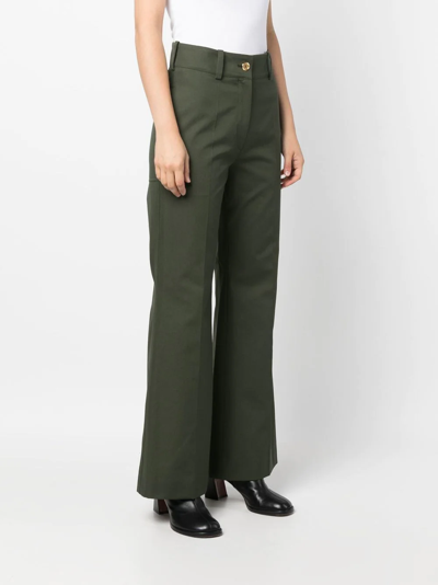 Shop Patou Logo-embroidered Flared Trousers In Green