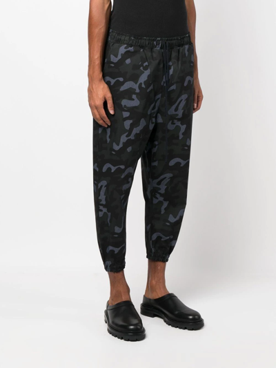 Shop Alchemy Camouflage-print Tapered Trousers In Black